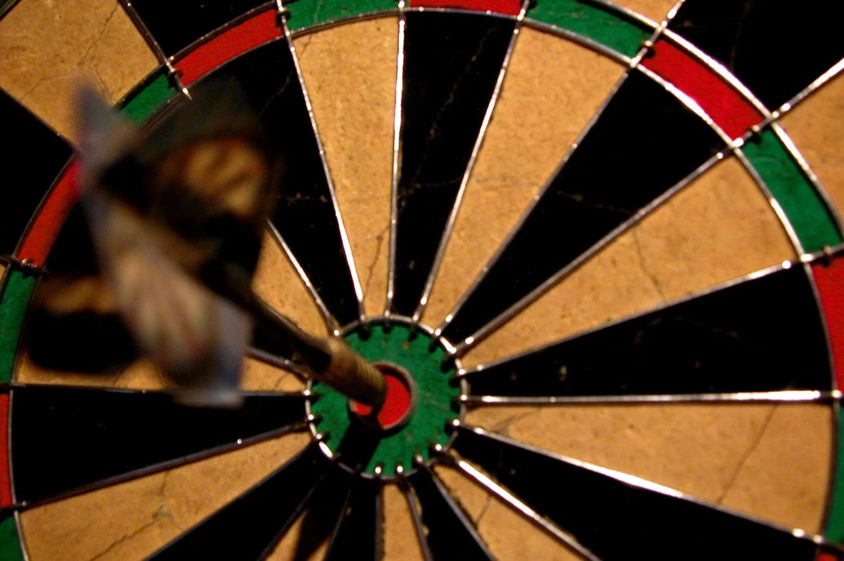 A person is playing with a dart board