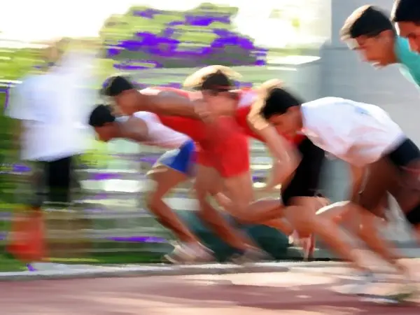A group of young men running on the track.