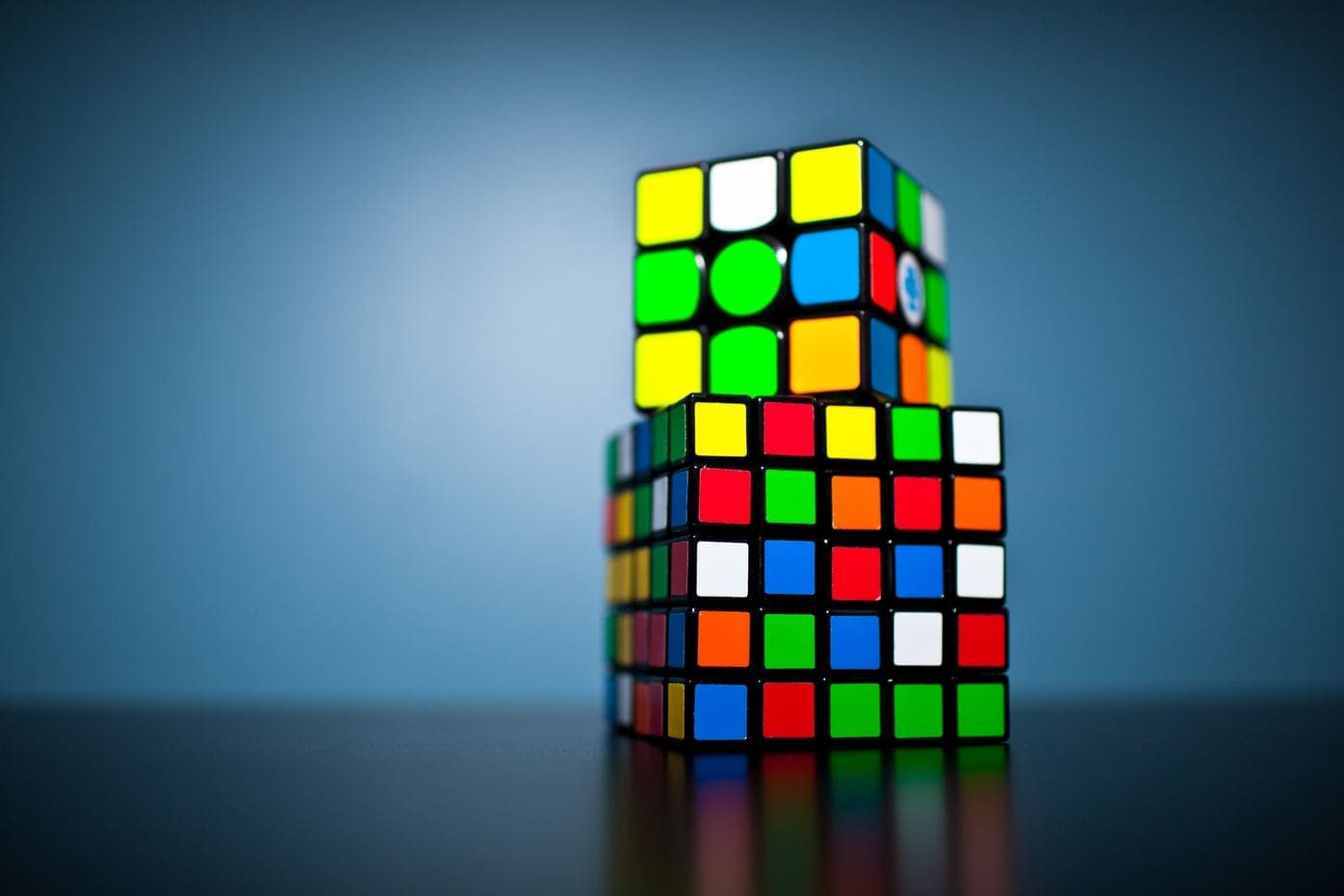 A stack of rubiks cubes on top of each other.