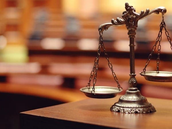 A close up of the scales of justice on top of a table